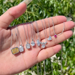 Macro shot of assorted S925 silver necklaces with colorful zircon and stone pendants