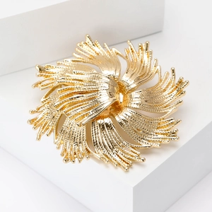 Élégante broche dorée en forme de feu d'artifice avec pétales radiaux et fini brossé