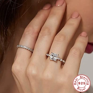 Detail of sterling 925 silver rings with square cut solitaire and pavé diamond band