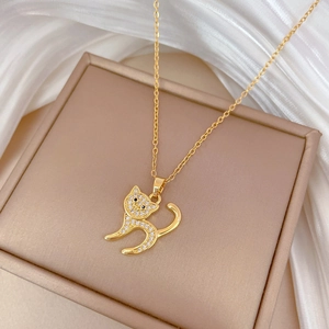 Elegant gold-plated cat pendant necklace with sparkling zircons on a champagne box