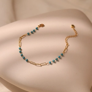 Elegant gold chain bracelet with turquoise blue beads and adjustable lobster clasp