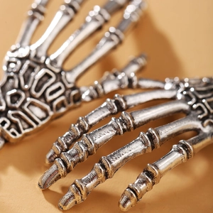 Retro gothic silver skeleton hand earrings featuring a BAD engraving for Halloween