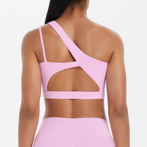 Detailed back view of pink sports bra featuring asymmetric straps and open back design