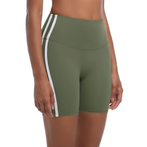 Detail of olive green high-waisted yoga shorts with two white side stripes on gray background