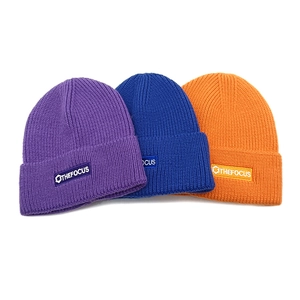 Chic ribbed knit beanies in purple, blue, and orange with branded logo patch for winter