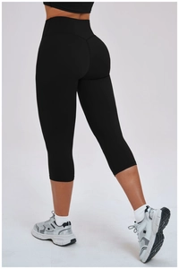 Back view of high-waisted black yoga capri leggings showing seamless lift design