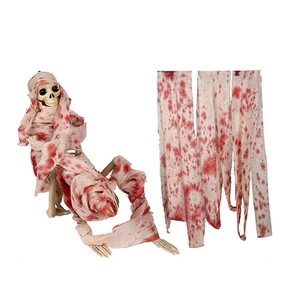 Close-up of Halloween bloody white gauze wrap with realistic red stains and plastic skull