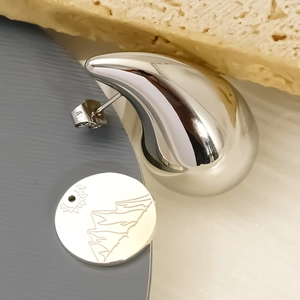 Polished silver stainless steel teardrop earrings with engraved mountain sun charms
