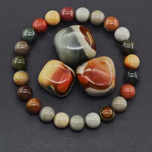 Macro view of natural mookaite jasper stone beads and polished raw gemstones texture