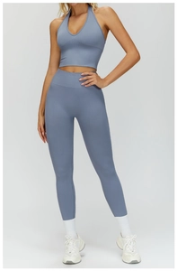 Macro view of seamless high-waist ribbed waistband on light blue yoga leggings