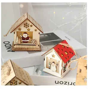Detail of wooden LED Christmas house ornament with cutout stars and warm glowing light
