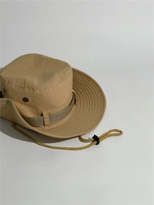 Detail of khaki outdoor bucket hat with breathable metal eyelets and adjustable chin cord