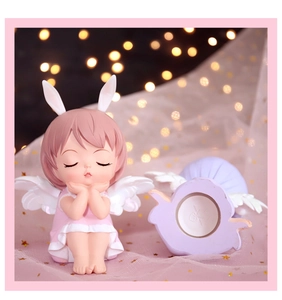 Pink haired angel girl figurine with bunny ears and wings used as a creative piggy bank