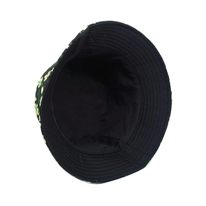 Reversible floral print bucket hat in black canvas with yellow flowers for sun protection