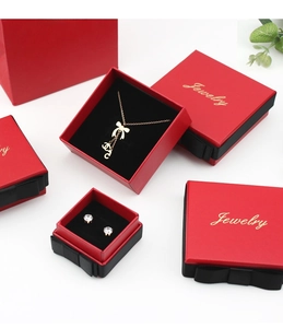 Detailed macro view of red jewelry boxes with black bows and golden Jewelry text