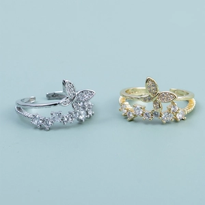Double-layer butterfly rings in gold and silver finish with zircon stones and open design