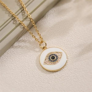 Golden necklace with circular evil eye pendant featuring blue crystals and white enamel