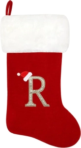 Detail of red Christmas stocking featuring gold embroidered letter R and plush white cuff