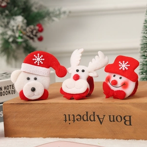 LED Christmas slap bracelets featuring elk, snowman and bear plush figures set on wood