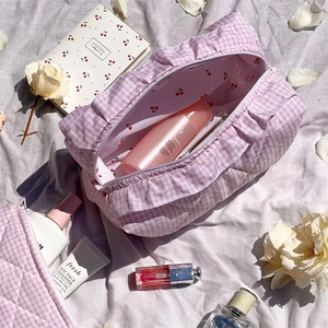 Detail of pink plaid velvet makeup bag with cherry lining and soft fabric texture
