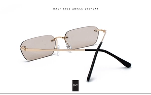 Detail view of rimless square sunglasses with gold metal frame and brown lenses