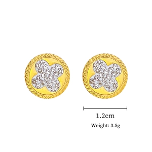 Detailed macro of golden four-leaf clover earrings with sparkling white rhinestones and rope edges
