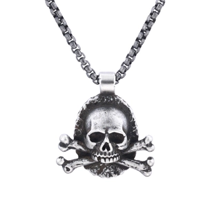 Vintage antique silver skull and crossbones pendant necklace on white background