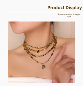 Detail of layered gold necklace featuring tiger eye pendant and mixed bead strands