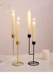 Detail of vintage iron double candle holders in black and gold finishes for home decor