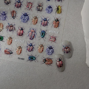 Detailed blue porcelain beetle nail stickers with realistic metallic insect designs