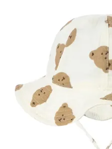 Detail of baby cotton bucket hat featuring brown bear prints and adjustable chin strap