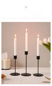 Three piece black metal candle holder set with round base for elegant table decor