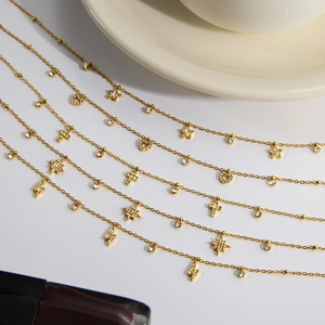 Macro view of five layered gold titanium steel necklaces with star and heart pendants