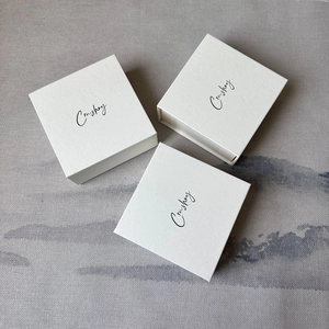 Set of three premium beige square magnetic book-style jewelry boxes with textured finish