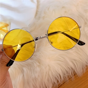 Detail shot of vintage silver metal frame sunglasses with translucent yellow round lenses