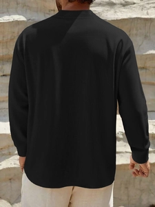 Detail view of the men's black casual shirt's back showing fabric drape and texture
