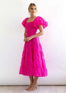 Detail of rose pink plaid puff sleeve dress featuring tiered skirt and ruched bodice