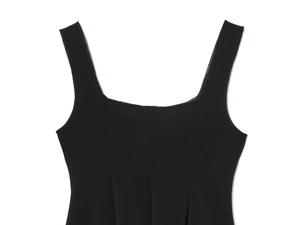 Detailed view of black square neck top with wide shoulder straps on white backdrop