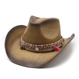 Detail of a brown woven cowboy straw hat with ethnic shell and colorful tassel band