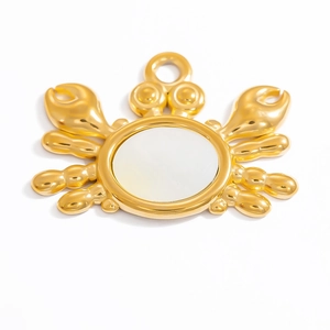Detailed view of crab pendant featuring 18k gold plating and white shell inlay detail