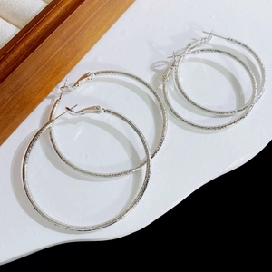 Frosted silver hoop earrings in large and small sizes with minimalist matte texture