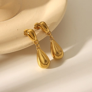 Polished 18k gold plated stainless steel teardrop earrings on a ceramic display