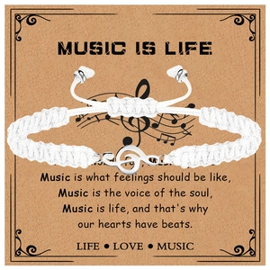 Detail view of white braided music bracelet with silver treble clef charm on gift card