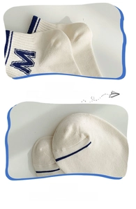 Detailed macro view of reinforced heel and seamless toe stitching on blue striped socks