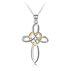 Detailed close-up of two-tone heart and cross pendant necklace in gold and silver finish