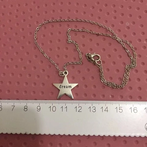 Star pendant necklace with dream engraving and size reference ruler for scale