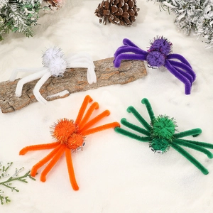 Handmade plush Halloween spider hair clips in four colors on a festive snowy background