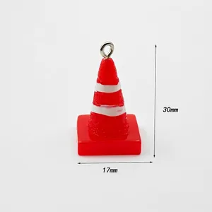 Detail shot of mini traffic cone charm with 30mm height and 17mm width dimensions
