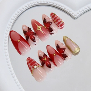 Deep red camellia and gold star press-on nails in long almond shape with 24 pieces