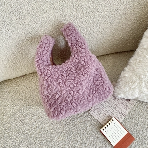 Close-up of purple teddy fleece texture and material detail of the mini handbag